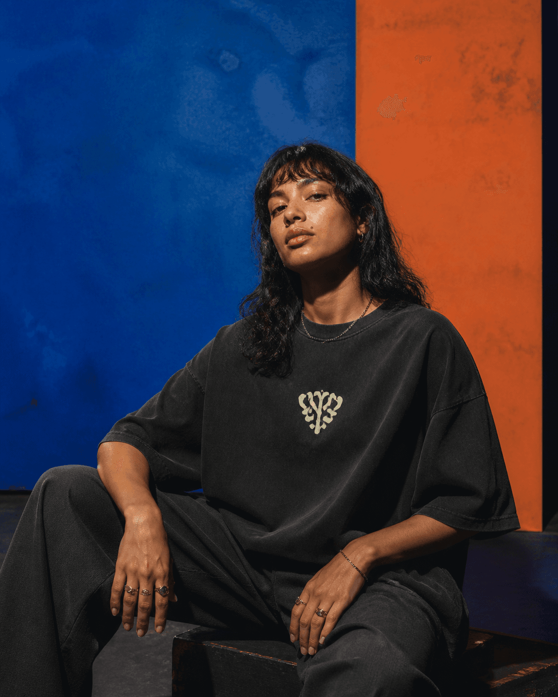 Editorial portrait of a person wearing a black diaspora-inspired tee